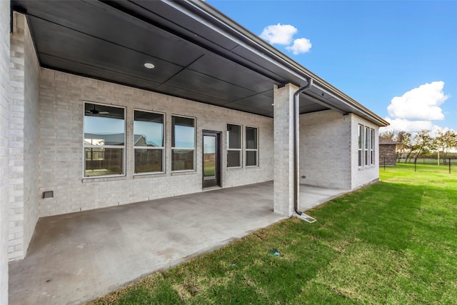 exterior space featuring a lawn and a patio area