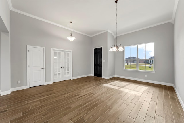 interior space with an inviting chandelier, dark hardwood / wood-style floors, and crown molding