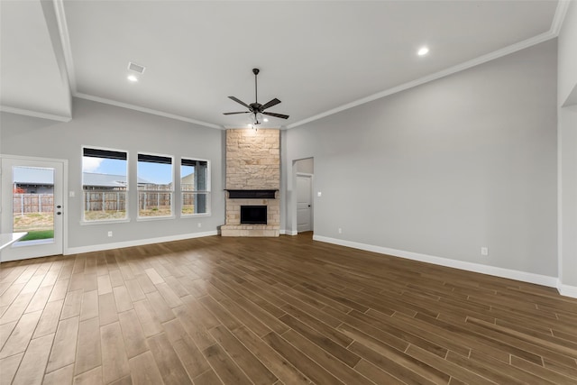 unfurnished living room with dark wood-type flooring, ceiling fan, ornamental molding, and a fireplace