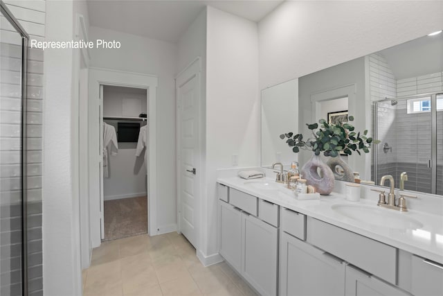 bathroom featuring tile patterned flooring, vanity, and a shower with shower door