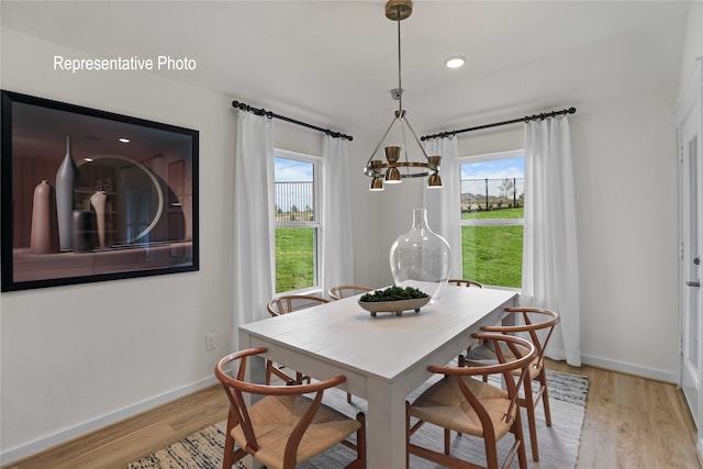 dining space with a wealth of natural light and light wood-type flooring