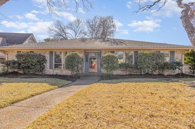 ranch-style house with a front lawn