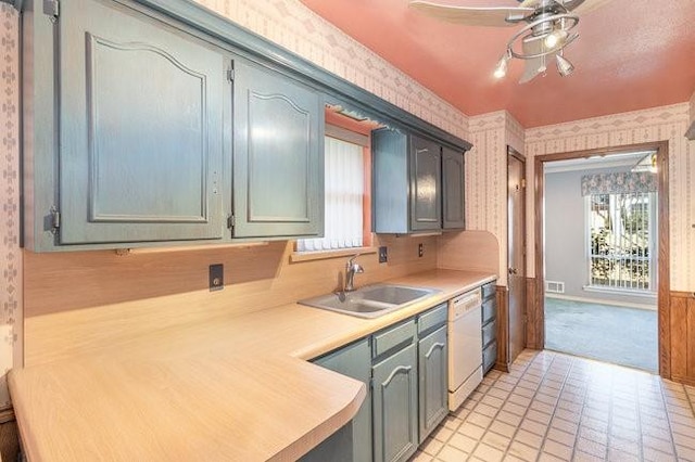 kitchen featuring dishwasher, plenty of natural light, sink, and light colored carpet