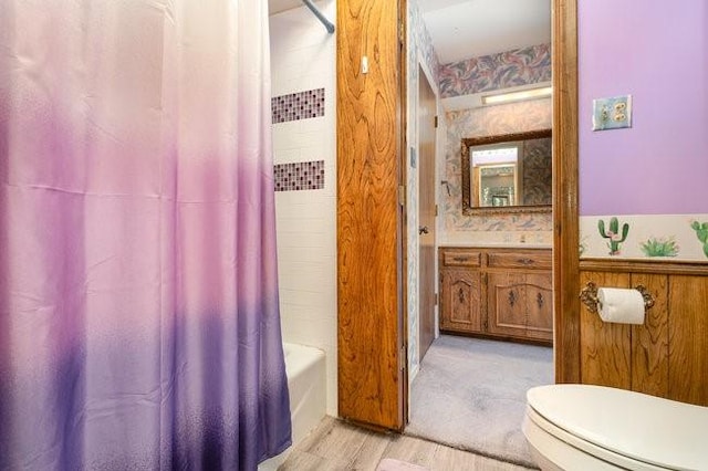 full bathroom featuring vanity, toilet, and shower / tub combo with curtain