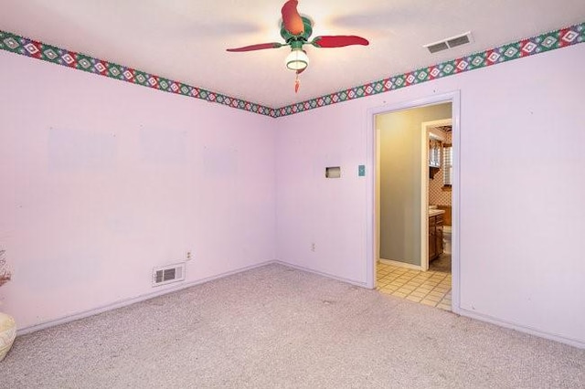 spare room with light carpet and ceiling fan