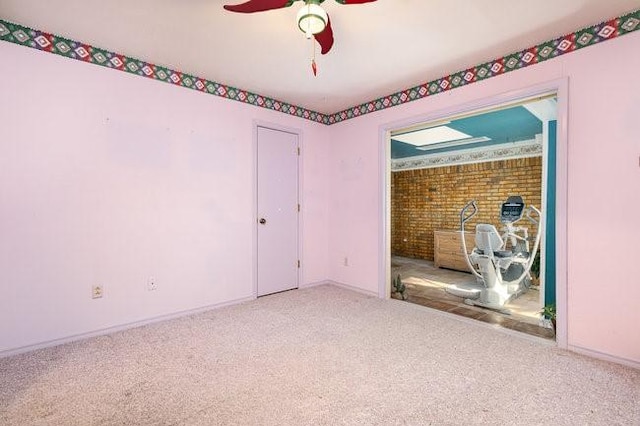 unfurnished room with carpet and ceiling fan