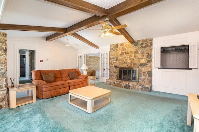 carpeted living room featuring lofted ceiling with beams, a stone fireplace, and ceiling fan