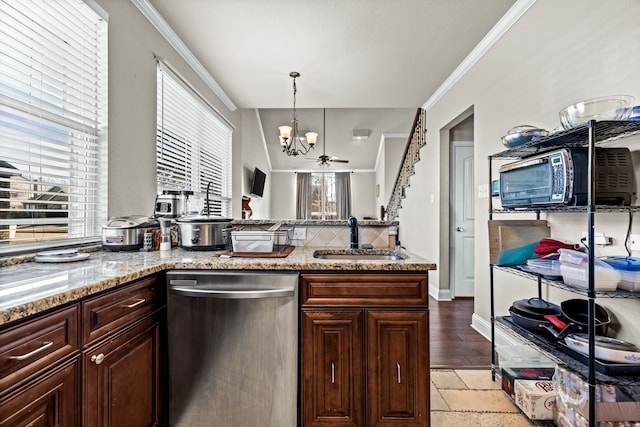 kitchen with stainless steel dishwasher, ceiling fan with notable chandelier, sink, and a wealth of natural light