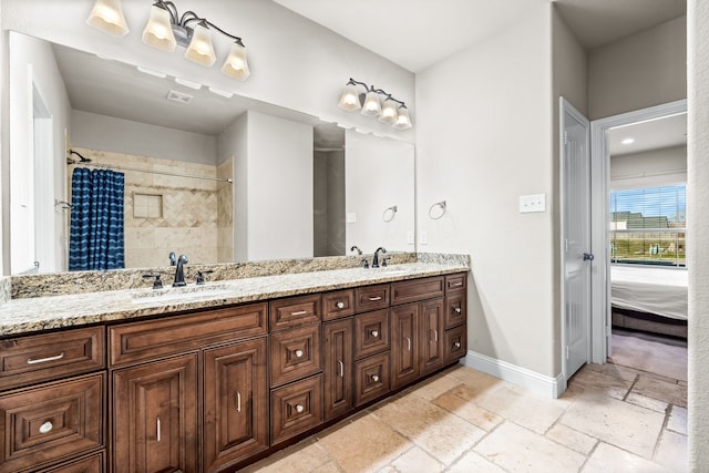 bathroom featuring vanity and curtained shower