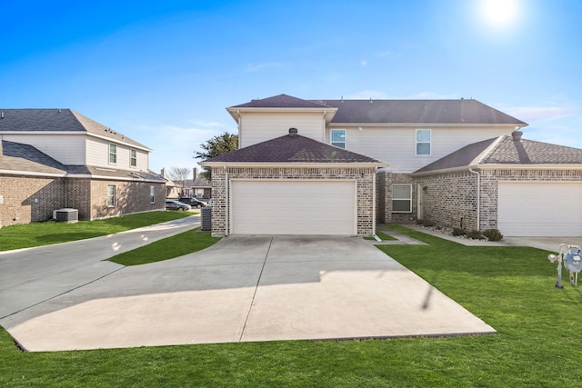 front facade featuring a garage and a front lawn