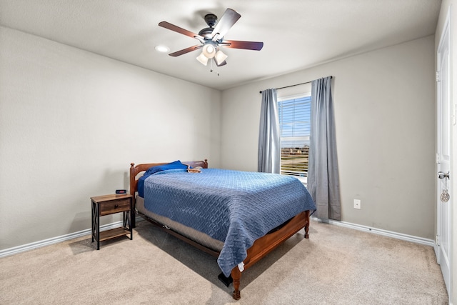 bedroom featuring ceiling fan and light carpet