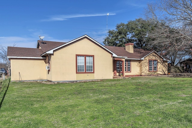 rear view of house featuring a yard