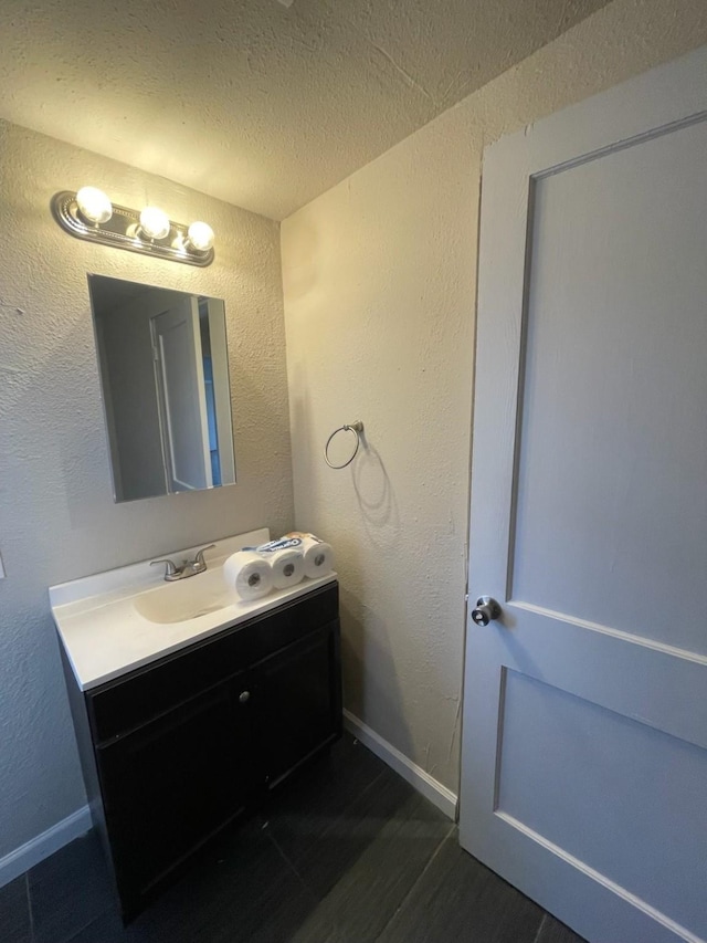 bathroom with vanity and a textured ceiling