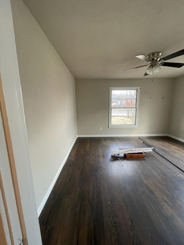 empty room featuring ceiling fan and dark hardwood / wood-style floors