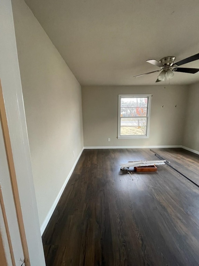 empty room featuring dark hardwood / wood-style floors and ceiling fan