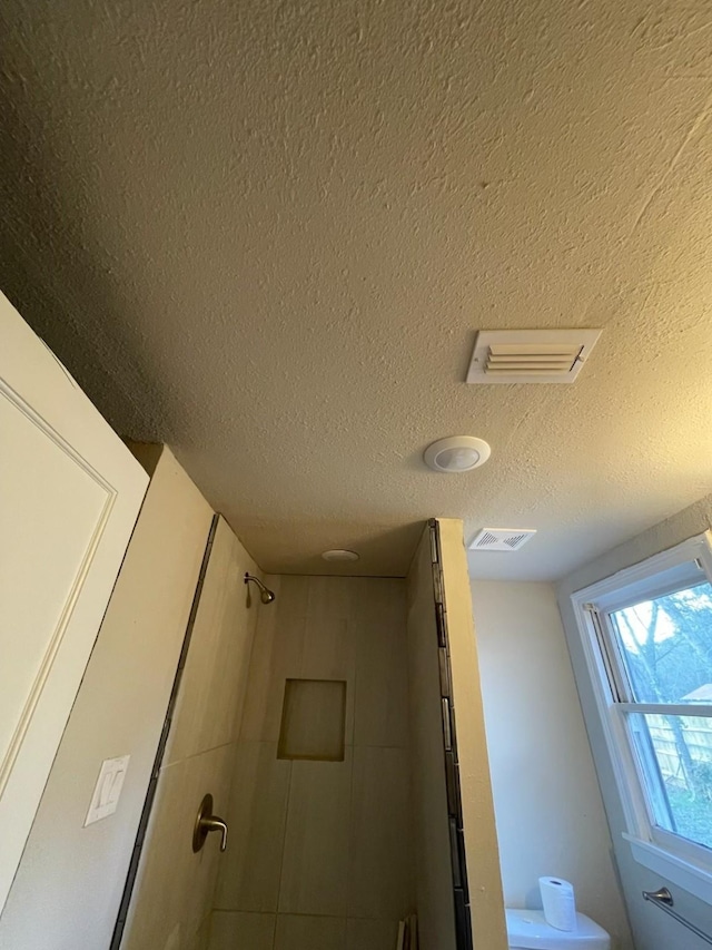 interior details featuring a textured ceiling