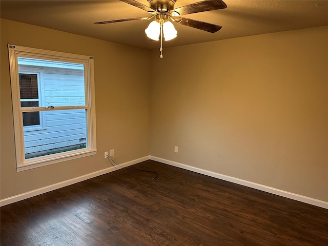 empty room featuring ceiling fan and dark hardwood / wood-style floors