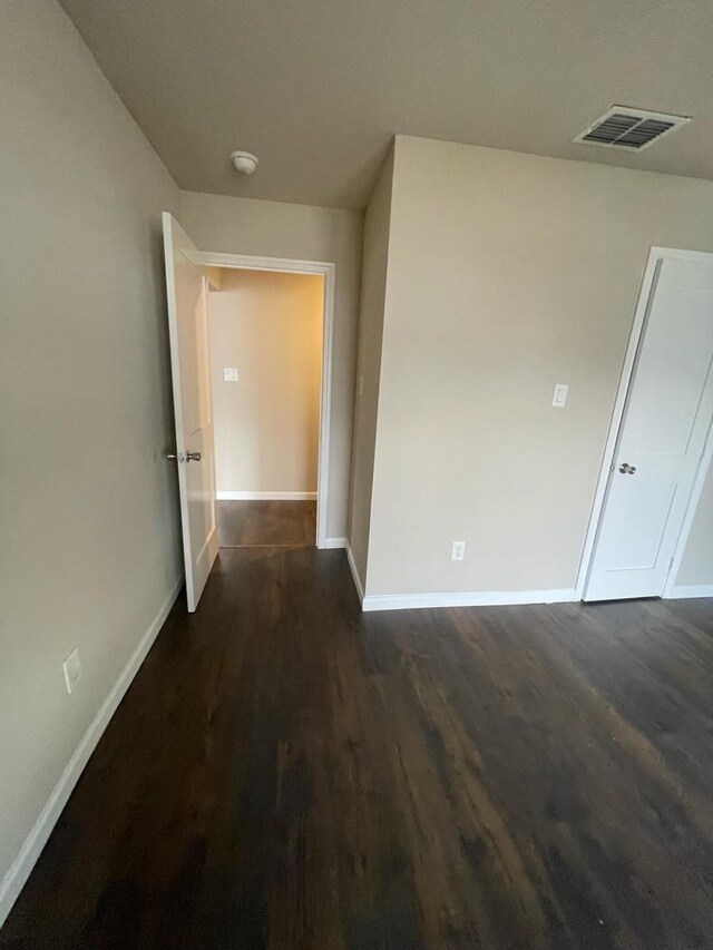 corridor with dark hardwood / wood-style floors