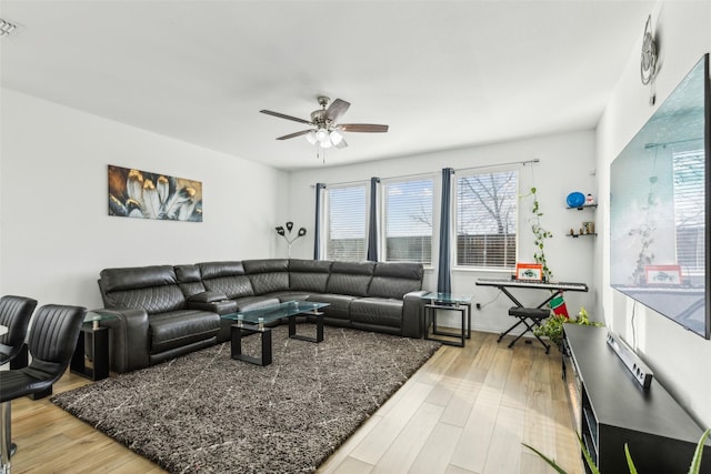 living room featuring hardwood / wood-style floors and ceiling fan