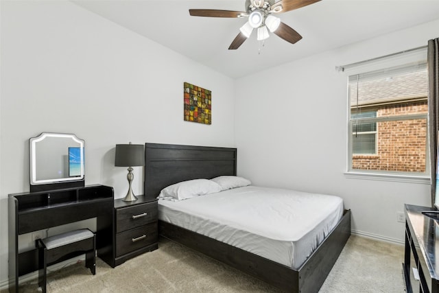 bedroom with ceiling fan and light carpet