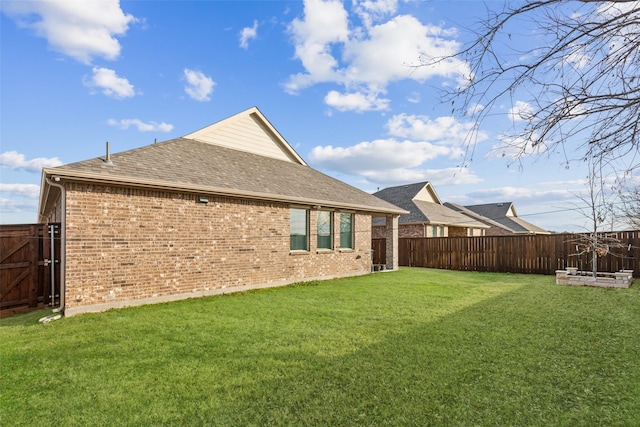 rear view of property with a yard