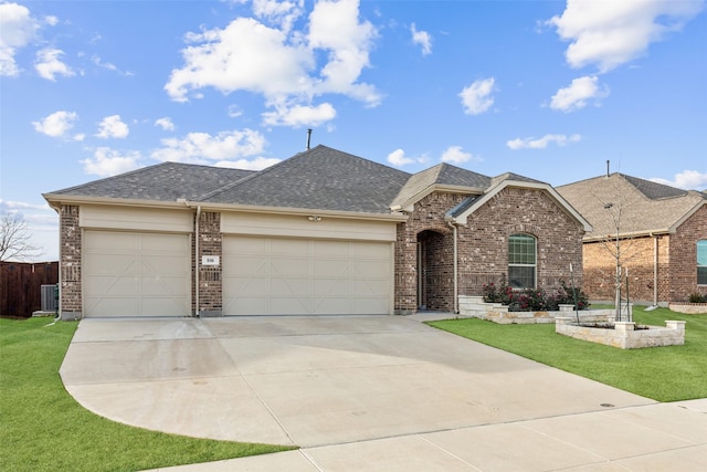 ranch-style house featuring a garage and a front lawn