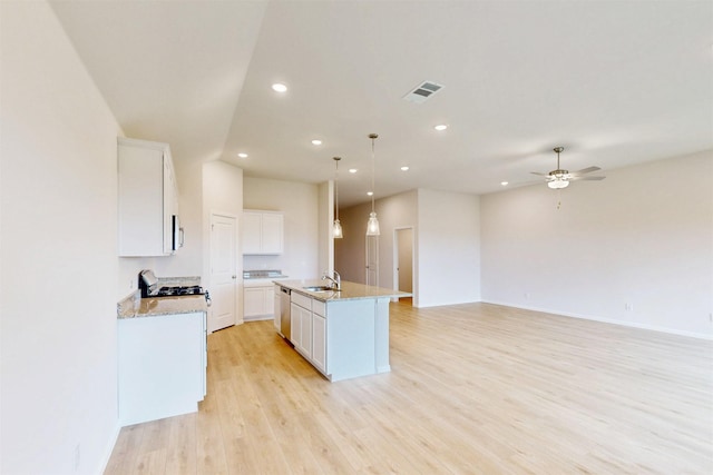 789 Merry Summit Rd, Lavon, TX 75166 - kitchen with a sink, an island with sink, white cabinetry, and visible vents