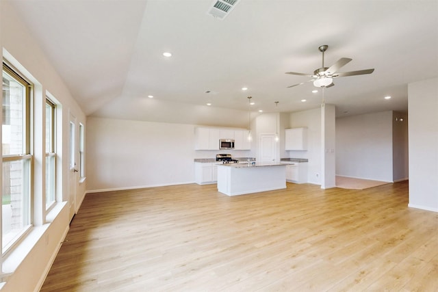 789 Merry Summit Rd, Lavon, TX 75166 - kitchen with a kitchen island with sink, visible vents, light wood-type flooring, open floor plan, and stainless steel appliances