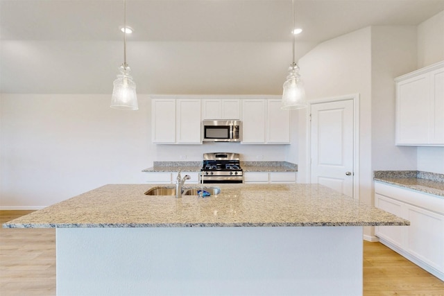 789 Merry Summit Rd, Lavon, TX 75166 - kitchen with light wood-style floors, an island with sink, white cabinetry, a sink, and stainless steel appliances