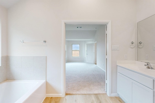 789 Merry Summit Rd, Lavon, TX 75166 - full bath featuring a garden tub, visible vents, wood finished floors, vanity, and baseboards