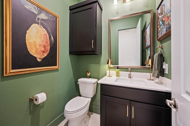 bathroom featuring tile patterned floors, vanity, and toilet