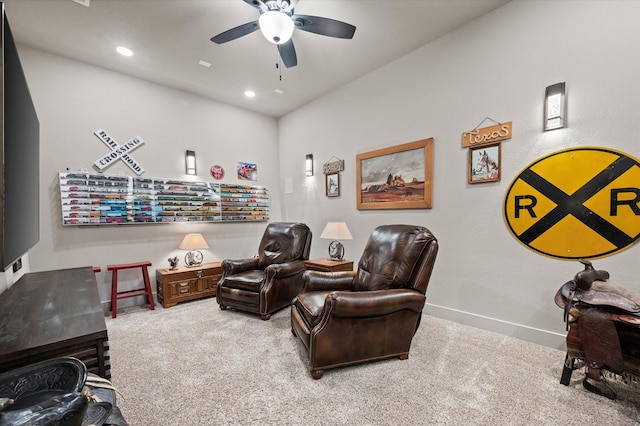 sitting room with ceiling fan and carpet floors