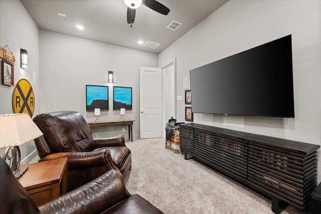 carpeted living room featuring ceiling fan