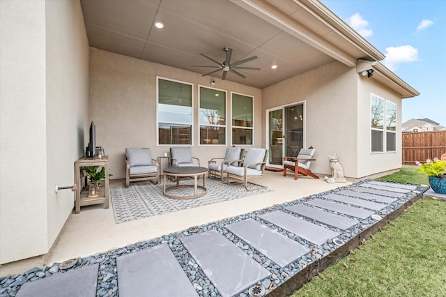 view of patio / terrace with ceiling fan and an outdoor living space