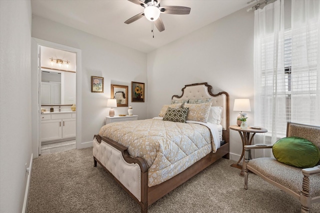 carpeted bedroom featuring ceiling fan and ensuite bath