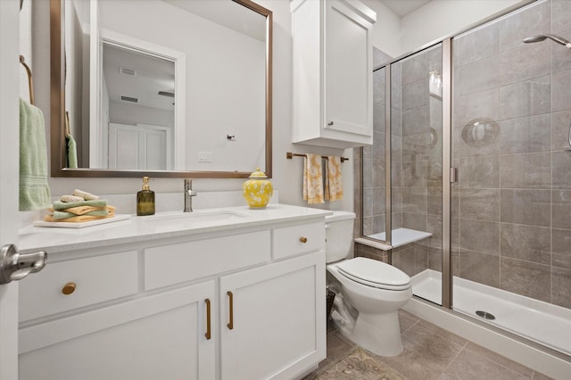 bathroom with vanity, toilet, and a shower with shower door