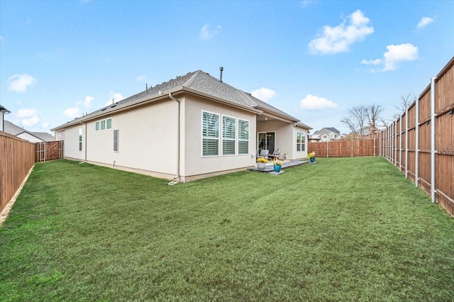 rear view of house featuring a lawn