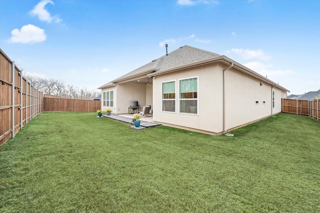 rear view of property featuring a lawn