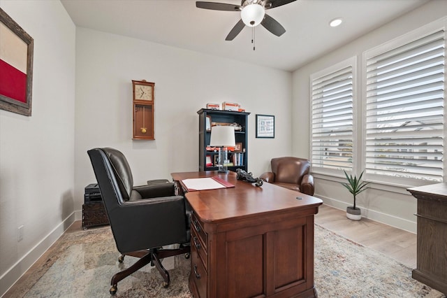 office space with ceiling fan and light hardwood / wood-style flooring