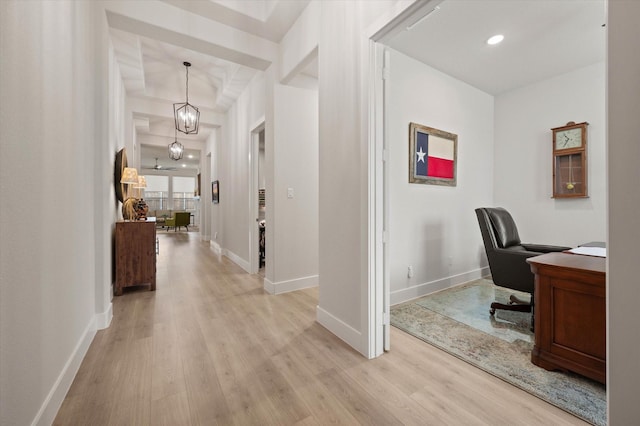 office area with light hardwood / wood-style flooring and a notable chandelier