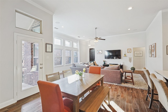 dining area with hardwood / wood-style flooring, ceiling fan, and crown molding