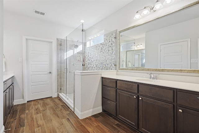 bathroom featuring vanity and a shower with shower door