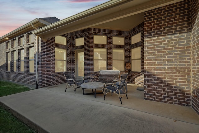 view of patio terrace at dusk