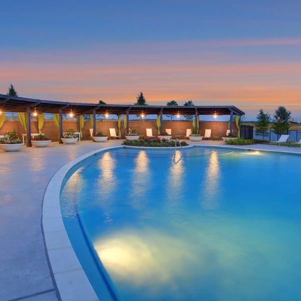 pool at dusk featuring a patio