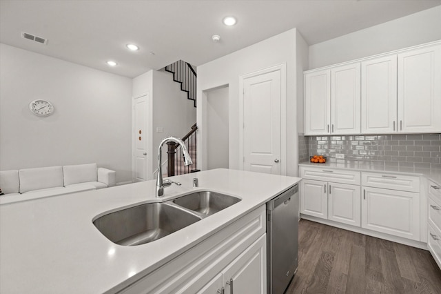 kitchen with dishwasher, tasteful backsplash, white cabinetry, and sink