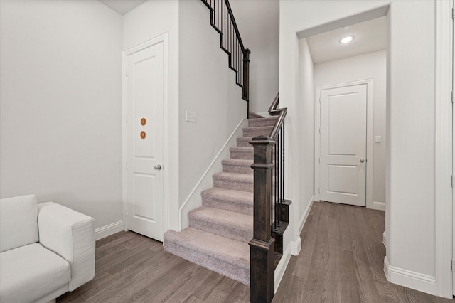 stairway featuring wood-type flooring