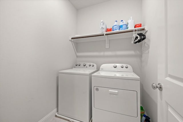 clothes washing area featuring separate washer and dryer