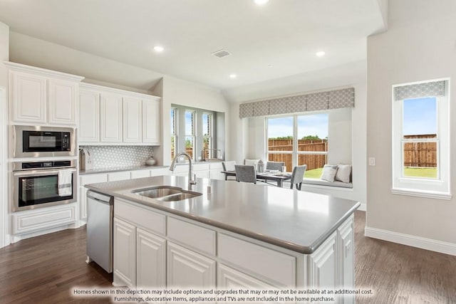 kitchen featuring a kitchen island with sink, sink, white cabinets, and appliances with stainless steel finishes