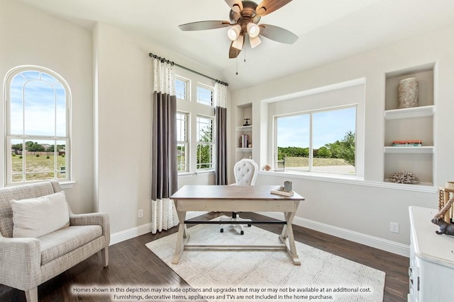 office space featuring built in shelves, vaulted ceiling, dark hardwood / wood-style floors, and ceiling fan