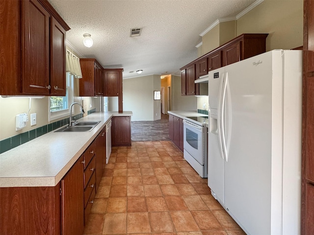 kitchen featuring sink, white appliances, ornamental molding, a textured ceiling, and kitchen peninsula